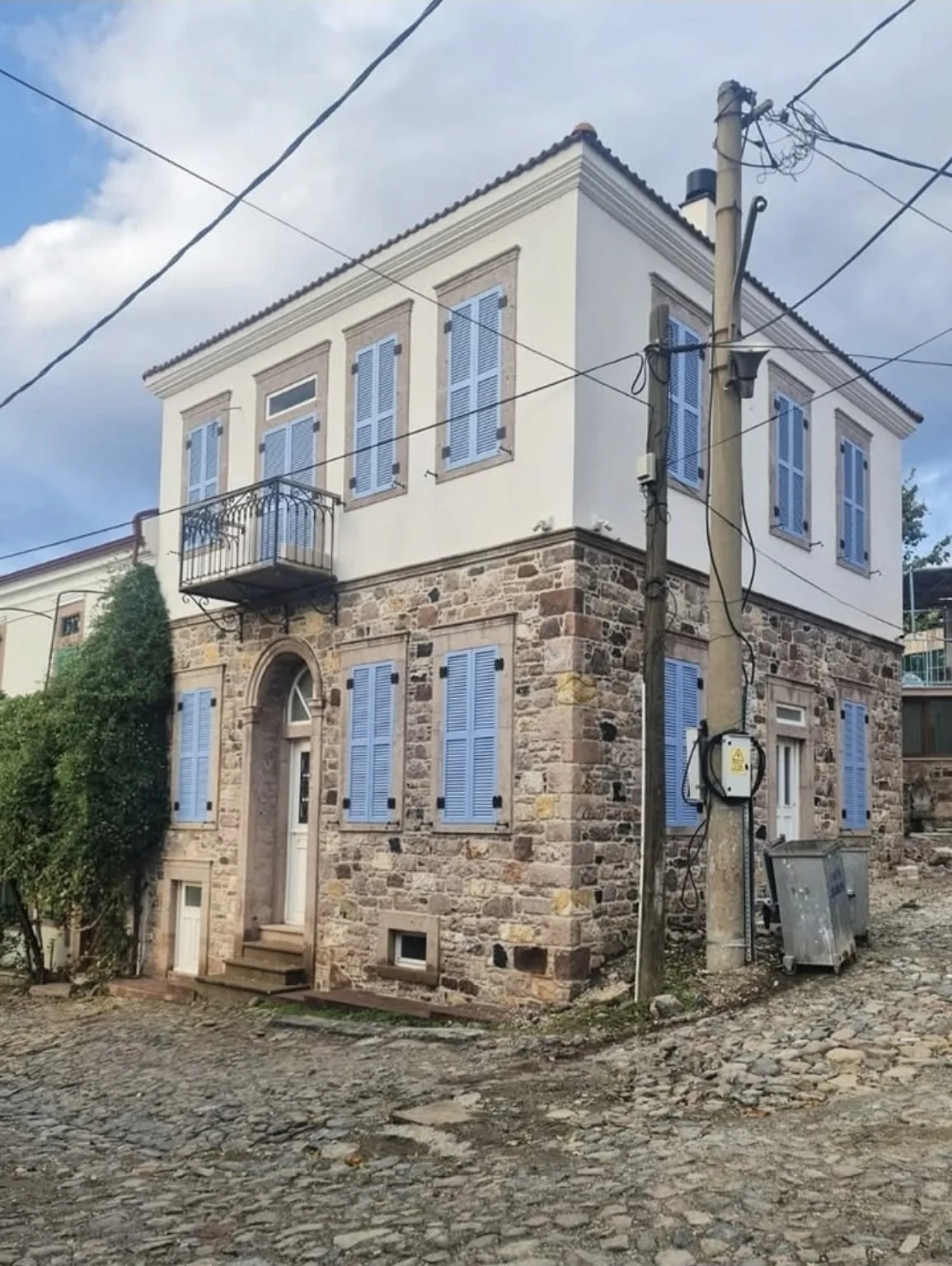 Mavi ahşap panjurlu taş yapı